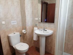 a bathroom with a toilet and a sink at El Cano Playa Victoria Grupo AC Gestion in Cádiz