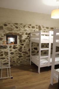 a room with two bunk beds and a rock wall at Casa Paula in Segurilla