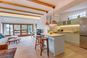 a kitchen and living room with a couch and a table at Villa Lavanda - Kandija in Cunski