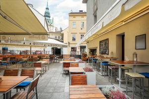 a restaurant with tables and chairs in a street at Hotel Esprit in Prague
