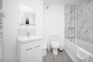 a white bathroom with a sink and a toilet at Modern 2 Bedroom Apartment - Secure Parking - 53C in Sleightholme