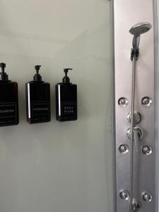 three bottles ofodorizers on a wall in a bathroom at Appartamento "In viaggio come a casa" vicino alla Stazione, LTScalo! in Monticchio +19 photos