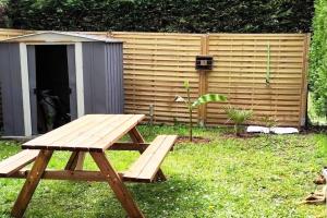 a picnic table in front of a shed at Appartement T3 calme avec jardin privatif in Pontoise