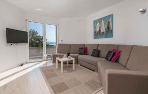 a living room with a couch and a tv at Holiday home in Poljane 47618 in Poljane