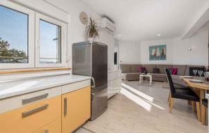 a kitchen and dining room with a dining table and a kitchen at Holiday home in Poljane 47618 in Poljane