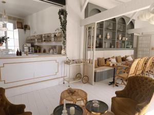 a room with chairs and tables and a kitchen at Maison Charmeilles - Gîte touristique - Villa in Fronsac