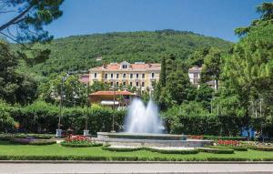 a fountain in a park in front of a building at Holiday home in Poljane 47618 in Poljane