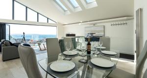 a dining room with a glass table with wine glasses at High Seas - NEW LISTING in Brixham