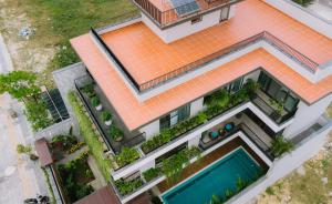 an overhead view of a house with a swimming pool at Peaceful Retreat Seafront Villa Da Nang in Danang
