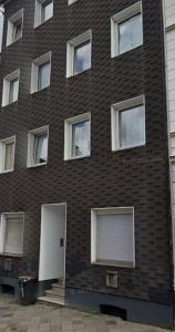 a brown brick building with a white door at Gemütliches Apartment Remscheid in Remscheid