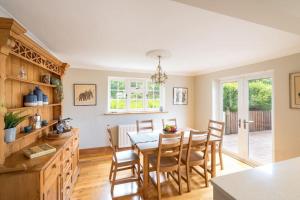 a kitchen and dining room with a table and chairs at Croft House Sleeps 8 ꕤ Country Views nr Salisbury in Salisbury