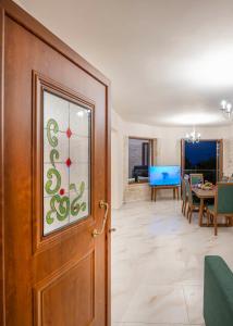 a door in a living room with a dining room at Maroulas Natura Palace in Giannoudi