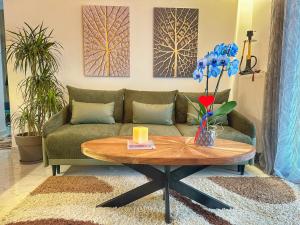 a living room with a couch and a table at Psimithefto Luxury Apartments in Thessaloniki