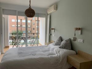 a bedroom with a large bed and a large window at Piso en Arturo Soria para 5 personas cerca del Aeropuerto y de IFEMA in Madrid