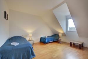 a attic bedroom with two beds and a window at Large contemporary pavilion on a hill overlooking Amboise and its château in Amboise