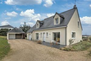 a white house with a black roof and a driveway at Large contemporary pavilion on a hill overlooking Amboise and its château in Amboise