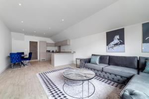 uma sala de estar com um sofá e uma mesa em Beautiful New Semi-detached 3 BR House wGarden em Brentford