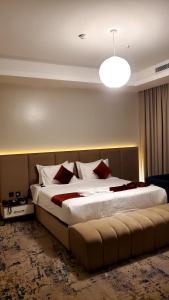 a large bed in a hotel room with a large bedvisor at Golden New Quraish Jeddah in Jeddah