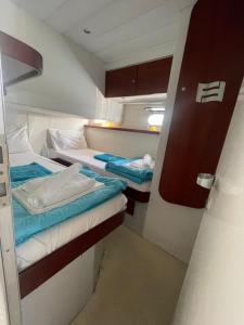a small room with two twin beds in it at Luxury Living on a Yacht in Mikonos