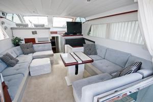 a living room with couches and a table in a trailer at Luxury Living on a Yacht in Mýkonos City