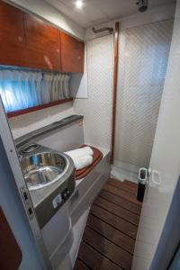 a small bathroom with a sink and a toilet at Luxury Living on a Yacht in Mikonos