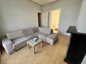 a living room with a couch and a table at Le Minimum in Liège