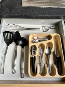 a tray filled with utensils on a kitchen counter at Le Minimum in Liège