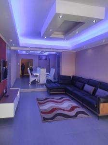 a living room with a couch and a table at Brand new crane Apartments in Lenasia