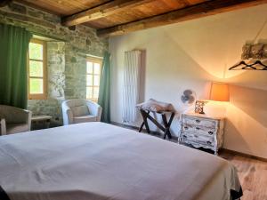 a bedroom with a bed and a table and chairs at B&B Barbaia in Levice
