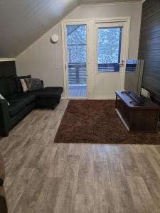 a living room with a couch and a table at Villa Sara in Kalajoki