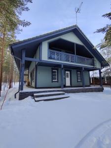 a house with a balcony in the snow at Villa Sara in Kalajoki