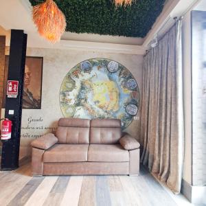 a living room with a couch and a mural at LOFT DELUXE - MADRID RETIRO in Madrid