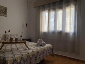 Schlafzimmer mit einem Bett mit einem Tisch und einem Fenster in der Unterkunft Casa melo in Martil