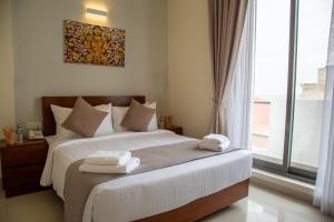Postel nebo postele na pokoji v ubytování Marine Suites