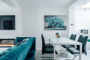 a living room with a couch and a table at Exceptional Whole House Chelsea with Roof Terrace in London