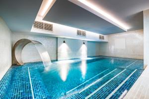 a swimming pool in a hotel room with a swimming pool at Harbour Hotel & Spa Brighton in Brighton & Hove