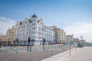 a large white building in the middle of a street at Harbour Hotel & Spa Brighton in Brighton & Hove