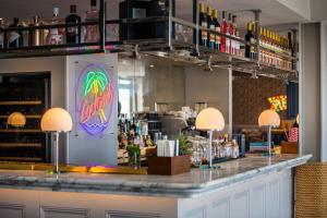 a bar in a restaurant with a counter with drinks at Harbour Hotel & Spa Brighton in Brighton & Hove