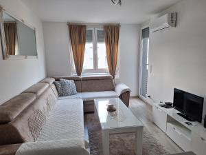 a living room with a couch and a table at Apartman-Stan in Bugojno