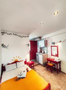 a bedroom with a large bed and a kitchen at Rena's Rooms Μελίντα in Melínta +19 photos