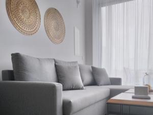 a living room with a couch and a table at Mythical Sands - Orion in Protaras