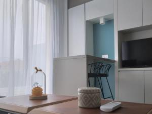 a living room with a table and a tv at Mythical Sands - Orion in Protaras +79 photos