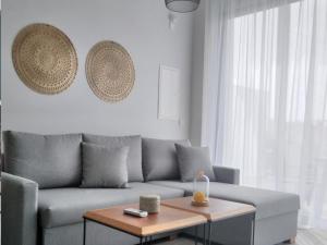 a living room with a couch and a coffee table at Mythical Sands - Orion in Protaras