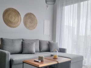a living room with a couch and a coffee table at Mythical Sands - Orion in Protaras