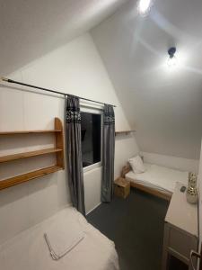 a small room with two beds and a window at Domek blisko granicy u Darka in Kunowice