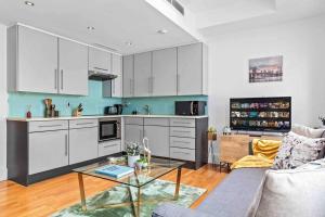 a kitchen with white cabinets and a table in a living room at Piccadilly,StJames,Mayfair in heart of London HY17 in London