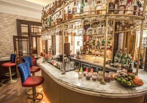 a bar with a lot of bottles on the wall at Harbour Hotel & Spa Bristol in Bristol
