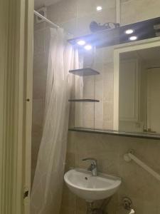 a bathroom with a sink and a shower curtain at Pantin Paris in Pantin +21 photos