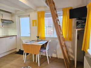 een kleine keuken met een tafel en een ladder bij Vakantiewoning in het centrum van Domburg DO29 in Domburg