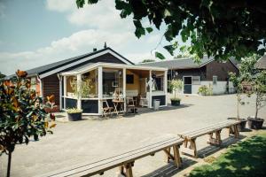 ein Haus mit einer Terrasse mit einem Tisch davor in der Unterkunft Hotel Lamperse Hei in Wanroij
